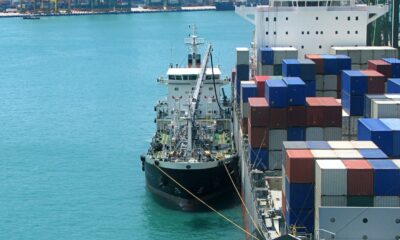 Bunker Holding:Bunker tanker vessel supplying marine fuel to a cargo ship at anchorage