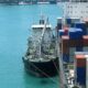 Bunker Holding:Bunker tanker vessel supplying marine fuel to a cargo ship at anchorage
